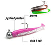 A jig fixed position lure with a silver bead and a vivid green groove and bright pink body.