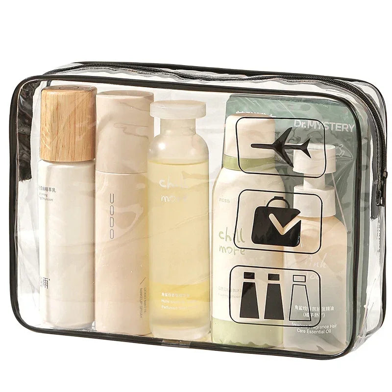 Clear toiletry bag containing three glass bottles of skincare products and one wooden tube.