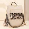 A beige fashion backpack with a leopard print flap and gold hardware.