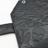 Black leather wallet featuring a vintage embossed design of skulls and skeletal elements.