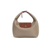 A beige nylon dumpling crossbody shoulder bag with a brown leather accent patch.