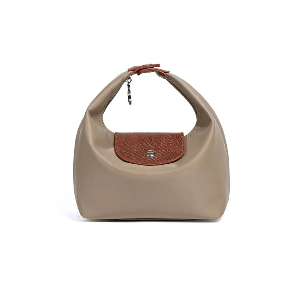 A beige nylon dumpling crossbody shoulder bag with a brown leather accent patch.
