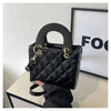 A black quilted diamond grid textured crossbody bag with gold hardware displayed against a white background.
