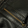 Close-up of a black vintage washed leather tote bag showing a stitched zipper detail.