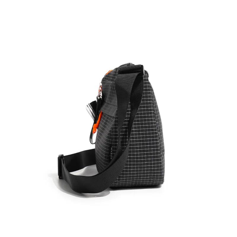 A black plaid water resistant crossbody shoulder bag shown against a white background.