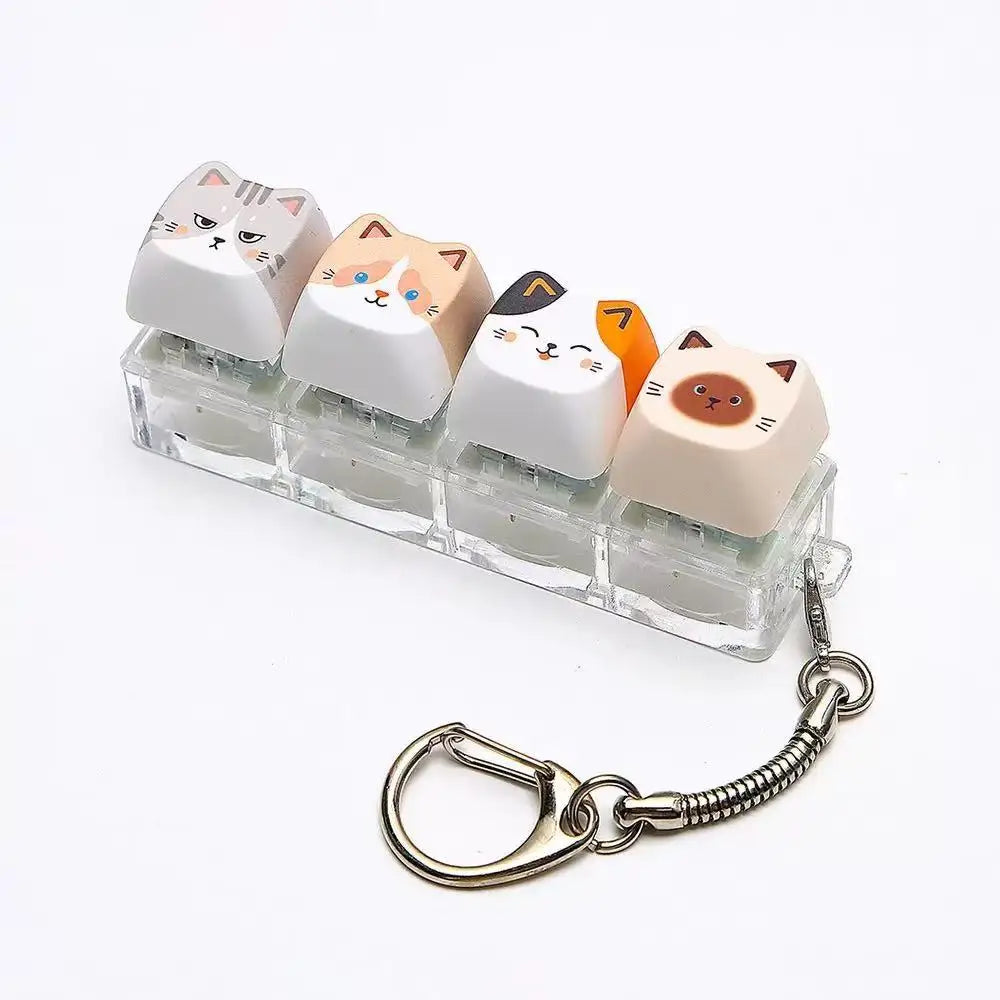 A set of acrylic cat keycaps used as a fidget toy attached to a silver metal lanyard.