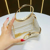 A hand holds an elegant satin pleated evening clutch bag with gold hardware on a white surface.