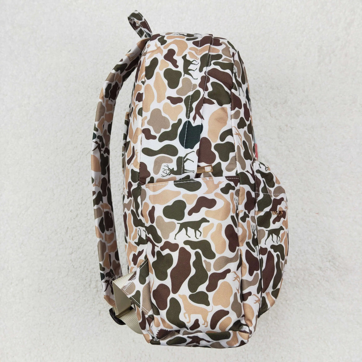 A camouflage patterned backpack featuring animal prints in brown, green, and tan colors.