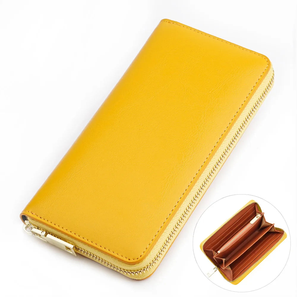 A yellow genuine leather zipper wallet shown with an open view of the interior.