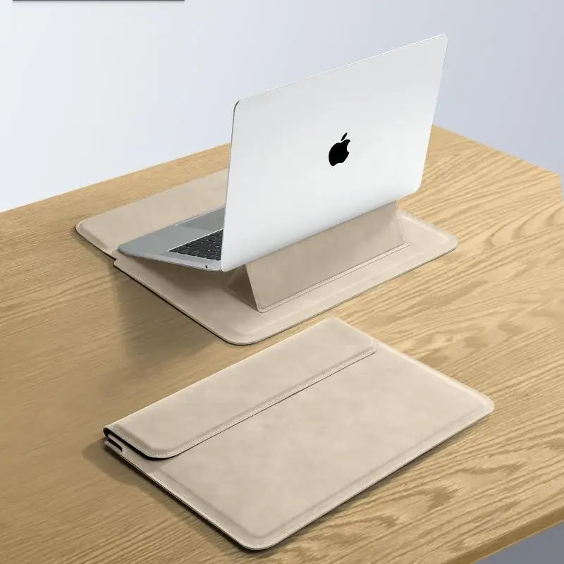 A white laptop is placed on a beige premium PU laptop sleeve on a wooden table.