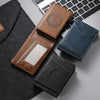 A collection of brown and blue anti-RFID blocking PU leather card holders resting on a gray surface.