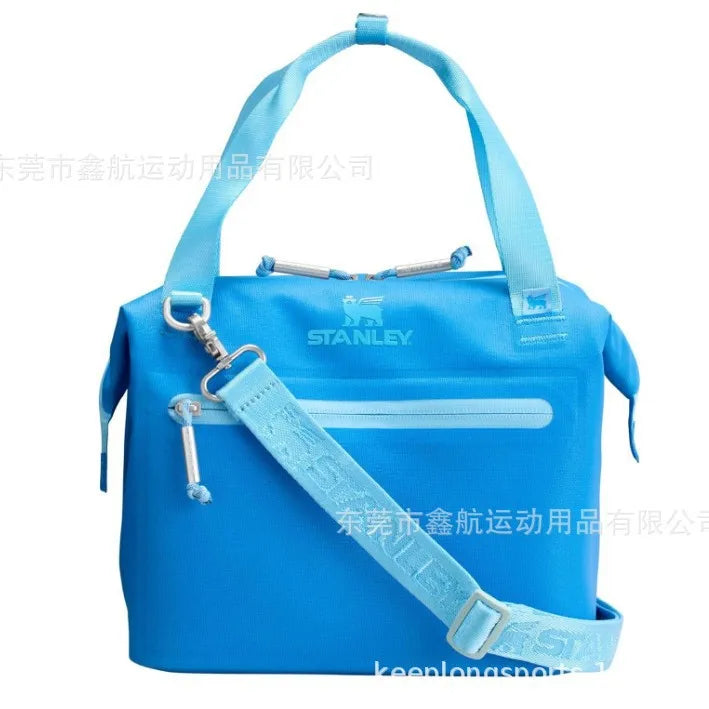 A bright blue insulated cooler lunch bag with a light blue detachable crossbody strap.