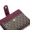 A maroon leather folding wallet with a patterned exterior and a matching sleeve.