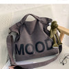 A dark gray canvas tote bag featuring the word MOOD printed in large, black letters.