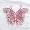 Pink rhinestone butterfly applique sticker with translucent wings on a white background