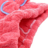 Primer plano de un lazo de microfibra color coral rosa y toalla de baño con ribete azul.