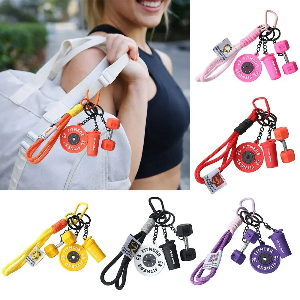 Various colored detachable dumbbell keychain charms on pink, orange, and purple cords.