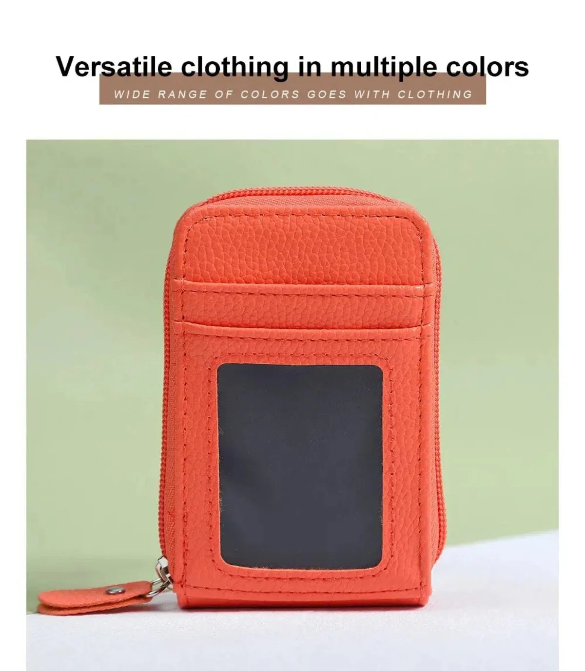 An orange slim leather wallet with a dark window is shown against a light green background.