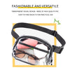 A clear PVC waist bag with an adjustable black strap, holding sunglasses and a pink object.