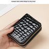 A black PU leather double-zip clutch wallet with a textured pattern is held in a hand.