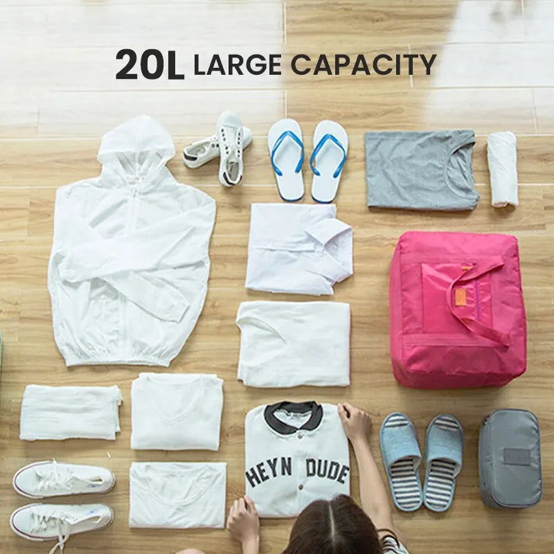 A collection of white and gray clothing items, including shirts, pants, and shoes, laid out on a wooden surface next to a pin