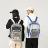 A person wearing a black shirt and beige pants is holding a clear waterproof backpack with a blue strap.