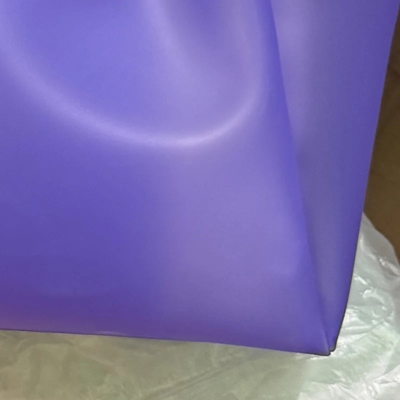 Sac en gelée transparent violet montré de profil sur fond blanc.