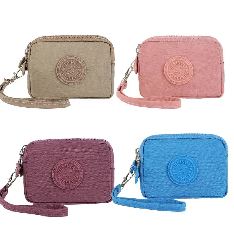 Three color compact nylon zipper pouches in beige, pink, purple, and blue.