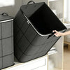 A black foldable storage organizer bag with a slanted opening is shown next to a vertical storage container.