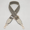A beige and black checkered braided nylon bag strap with metal hooks.