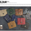 A collection of genuine leather card wallets in various colors and textures laid out on a dark surface.