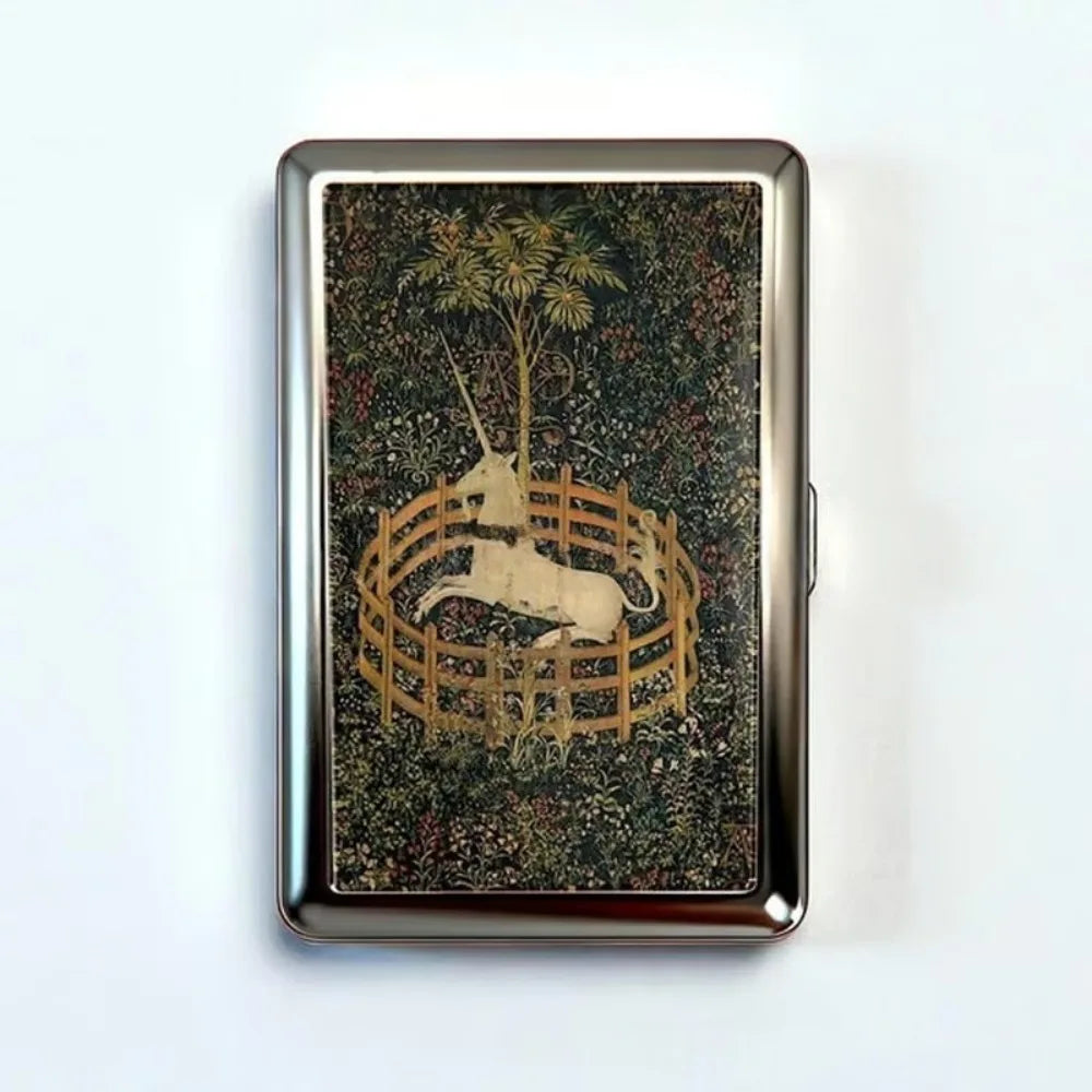 A vintage metal card holder with an engraved design of a silhouette of a deer within a circular wooden frame on a dark backgr