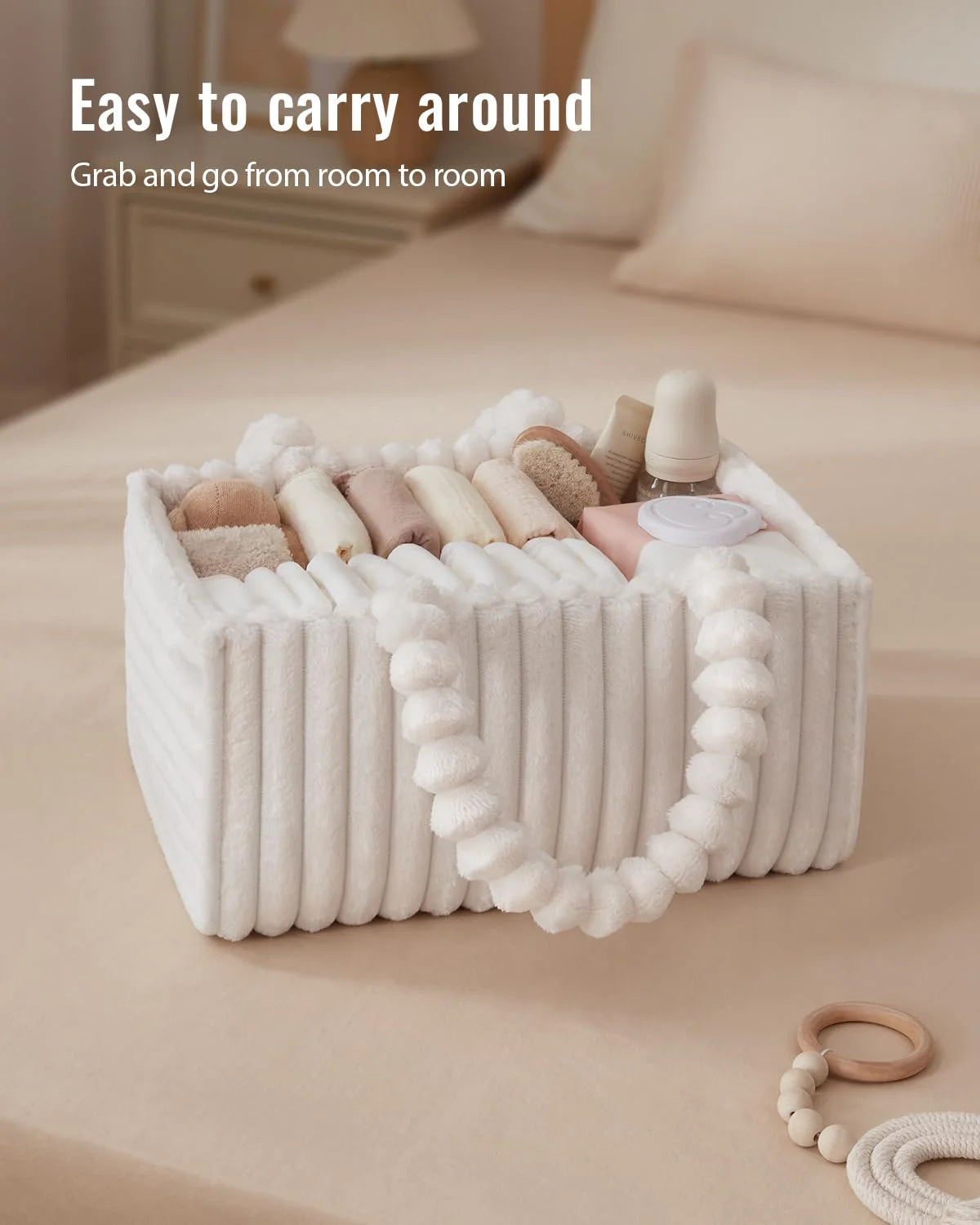A white flannel diaper caddy organizer filled with various baby items, shown on a beige surface.