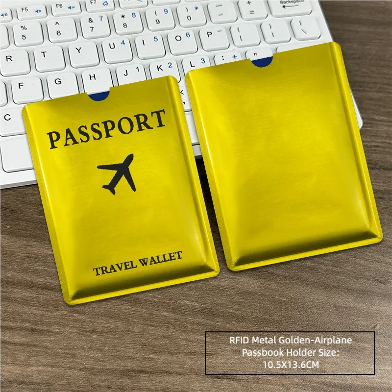 A yellow RFID metal passport holder next to a laptop keyboard.