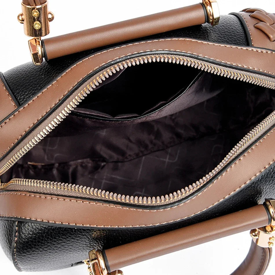 A brown leather shoulder crossbody bag with a zippered compartment shown from the top view.