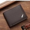A dark brown slim leather wallet with a money clip is shown resting on a wooden surface.