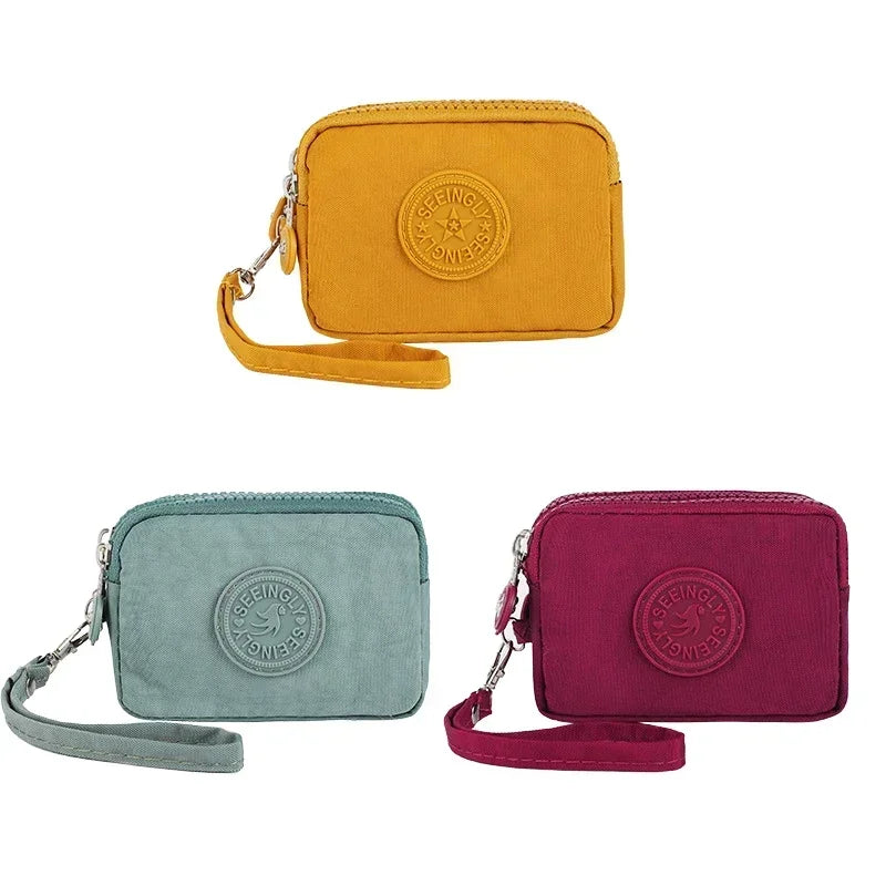 Three color compact nylon zipper pouches in yellow, mint green, and magenta.