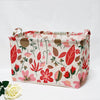 A fabric storage basket with handles featuring a floral pattern in shades of red, pink, and green.