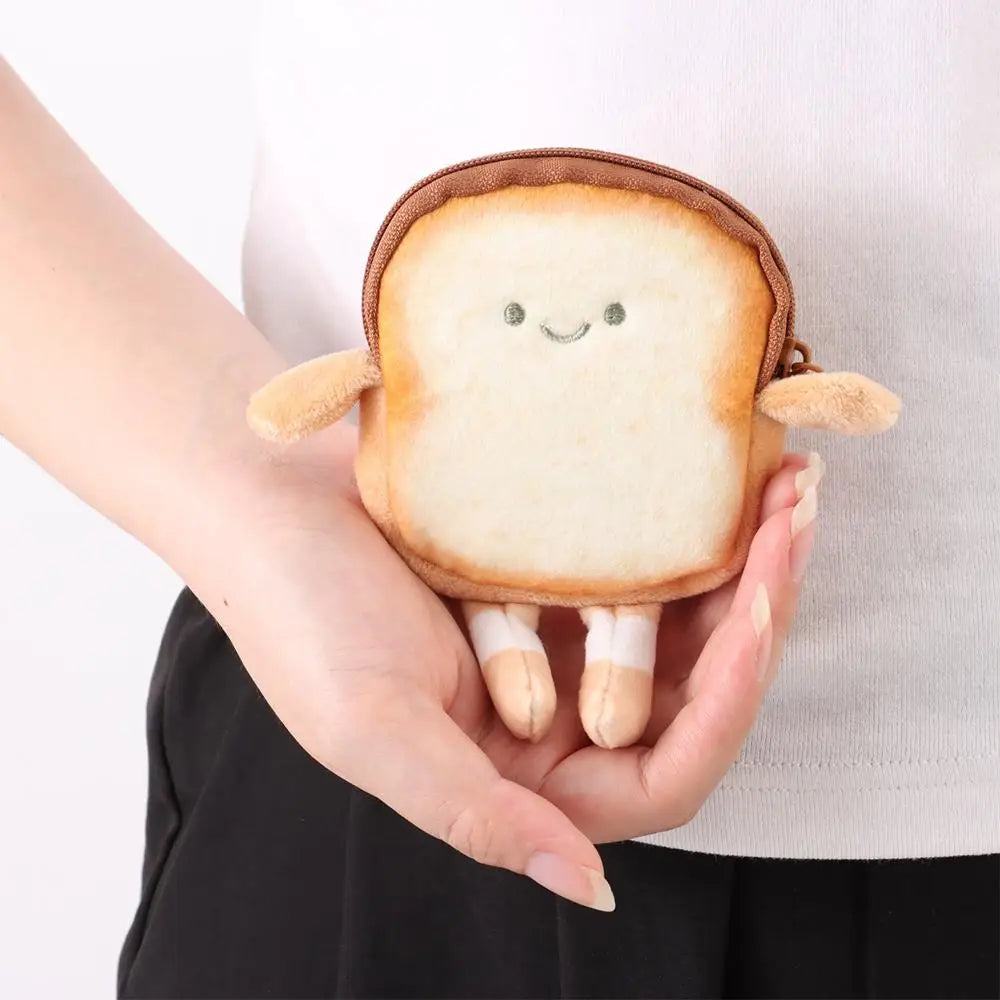 A hand holds a cartoon toast bread plush coin purse with small arms and feet.