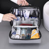 A hand opens a portable waterproof travel toiletry bag revealing various grooming products inside.