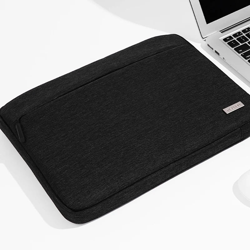 A black multi-pocket laptop sleeve with a handle is shown on a white surface.