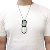A close-up of a personalized military dog tag necklace set with two oval pendants on a white t-shirt.