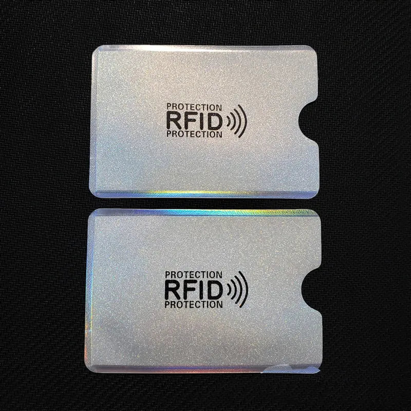 Two clear plastic cards showing the RFID protection logo on a dark background.