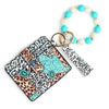 A silicone bead and leather card wallet featuring a leopard print design and white and turquoise beads.