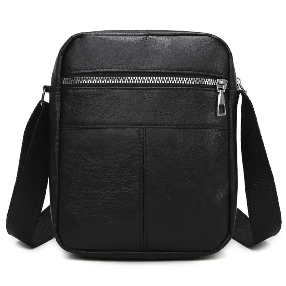 Black waterproof PU leather sling bag with a zippered front pocket and adjustable strap.