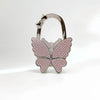 Silver foldable butterfly shaped handbag hook with pink textured detail