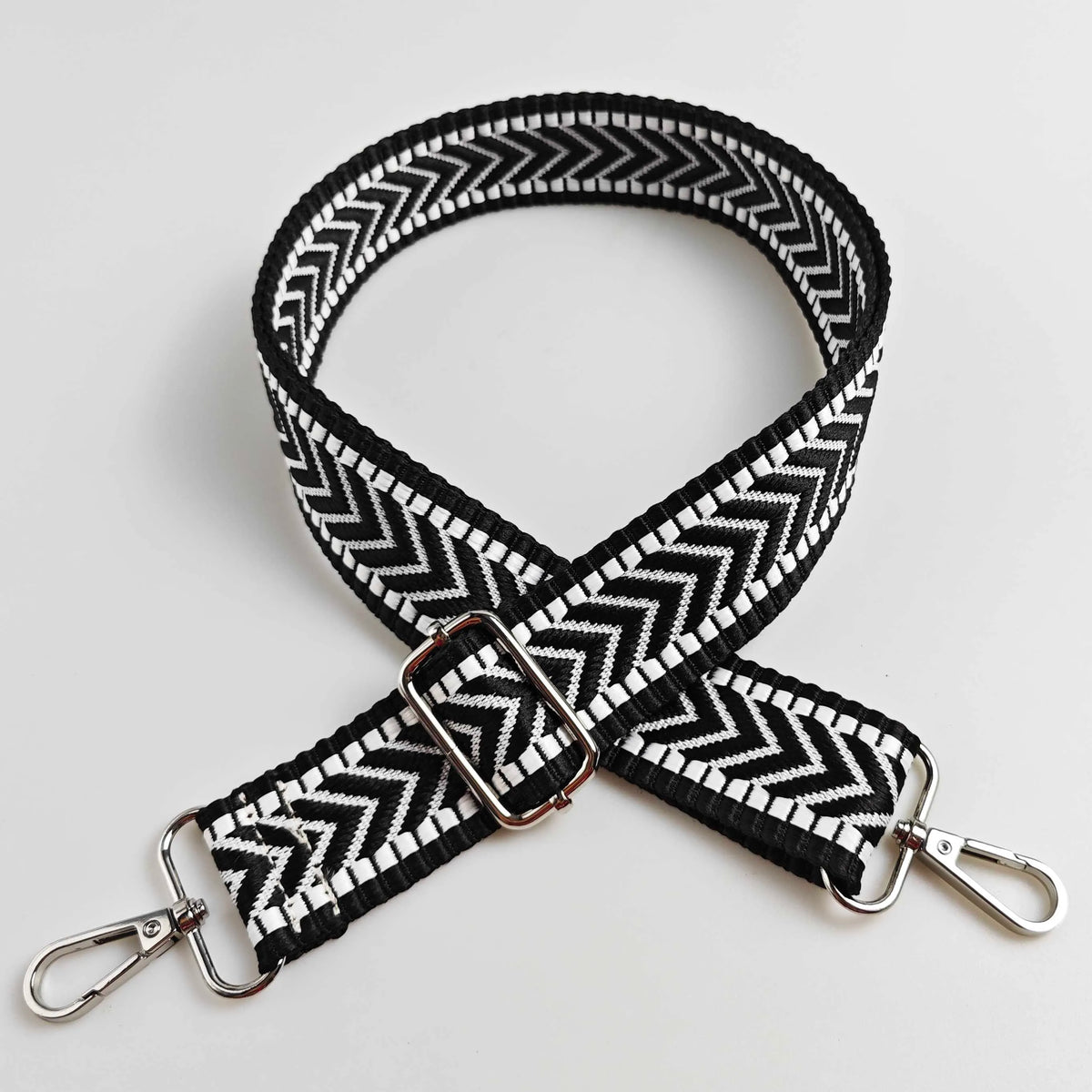 Black and white chevron patterned adjustable handbag strap with silver hardware
