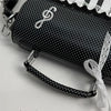 Black crossbody bag with piano note embroidery and white lace detail