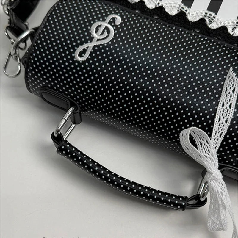 Black crossbody bag with piano note embroidery and white lace detail