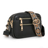 Black PU leather crossbody bag with gold hardware and a patterned strap
